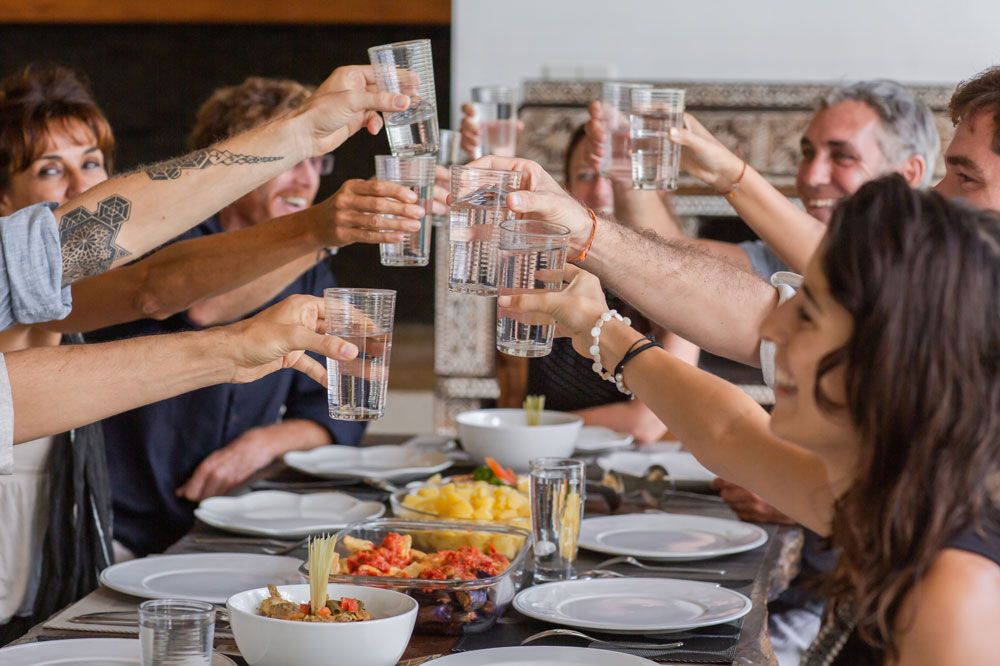 Large, crazy family toasting to a pregnancy announcement