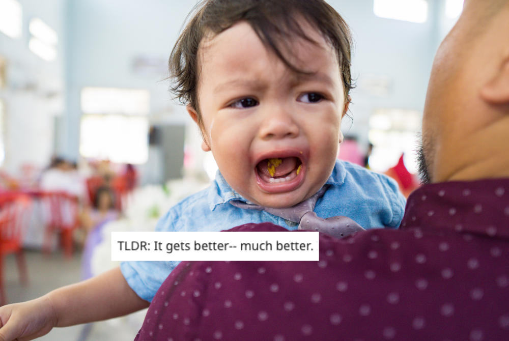toddler crying over dad's shoulder