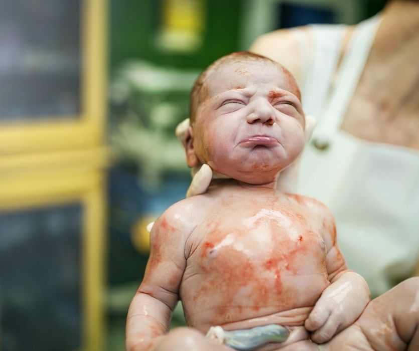 grumpy newborn baby right after being born