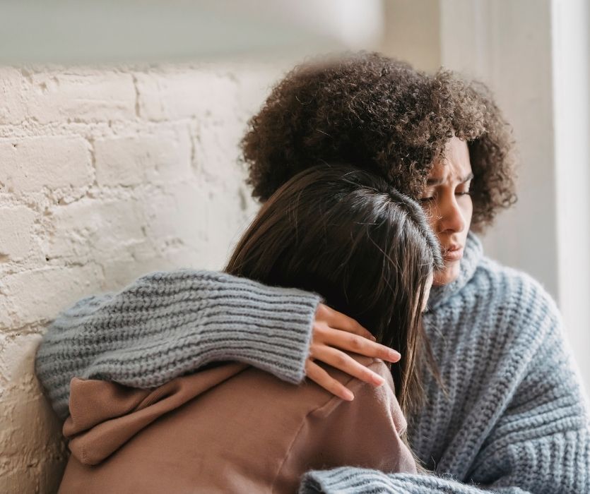 woman comforting friend who has lost a child