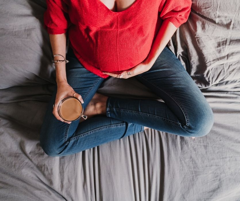 pregnant woman holding a cup of coffee