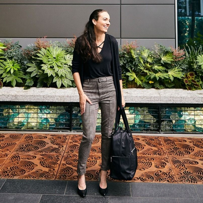 woman heading back to work holding a packed breast pump bag