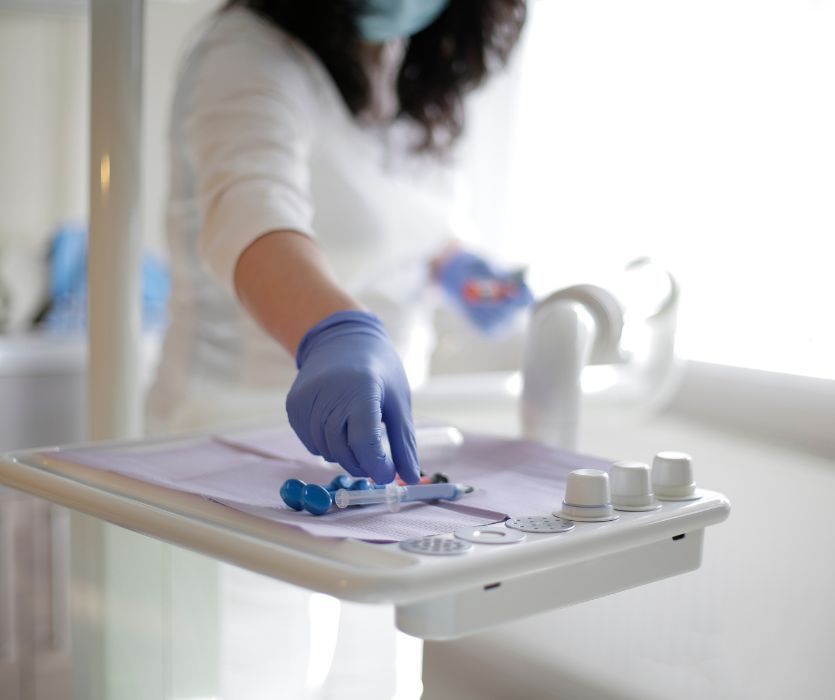 dentist reaching for tools on tray