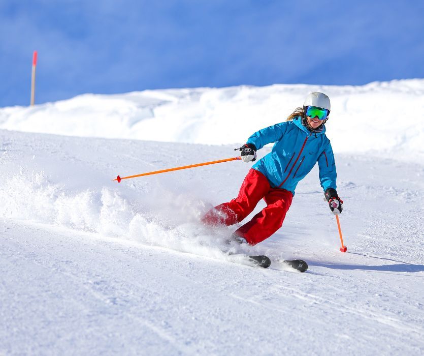 woman early in her pregnancy skiing on a snowy hill