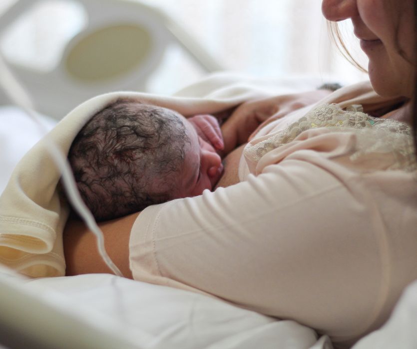 woman nursing her baby after having a natural childbirth
