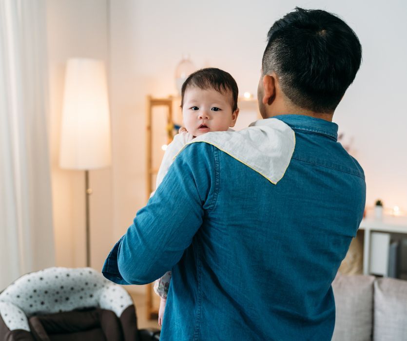 dad holding his baby suffering from reflux and GERD