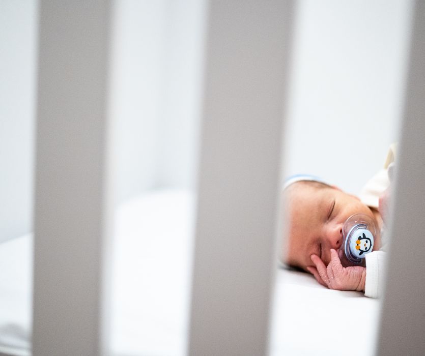 newborn baby sleeping soundly after parents get sleep tips