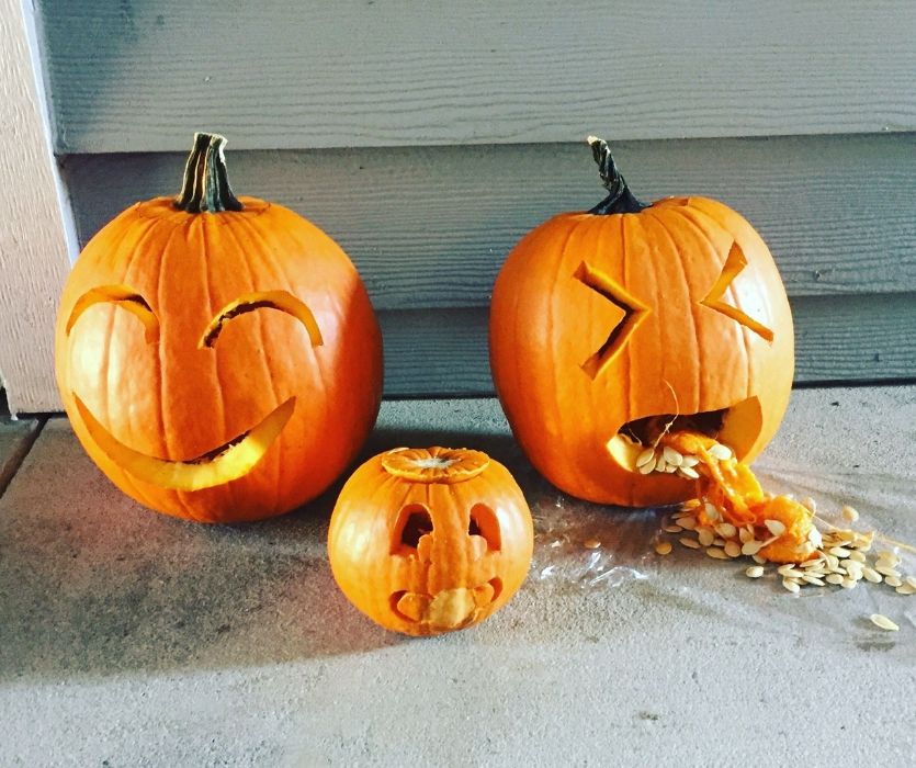 carved halloween pumpkins with a baby pumpkin and a pumpkin with morning sickness