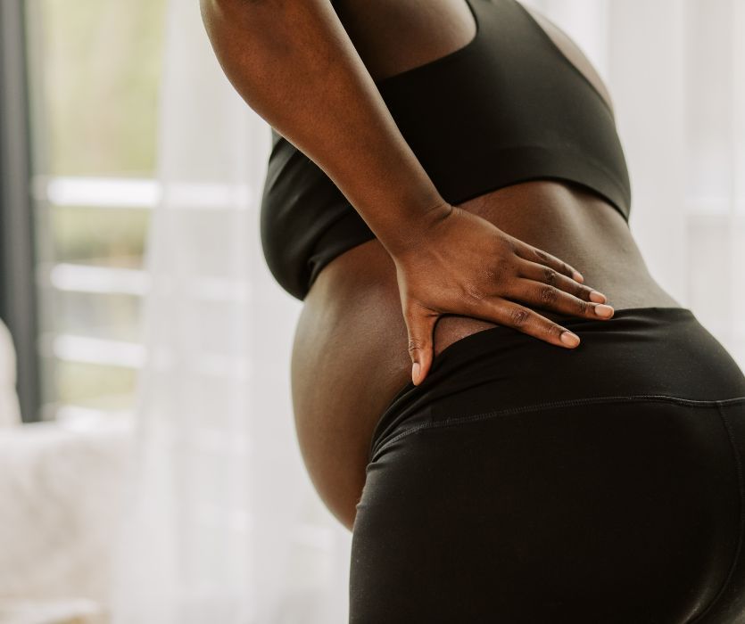 pregnant woman with placental abruption holding back in pain