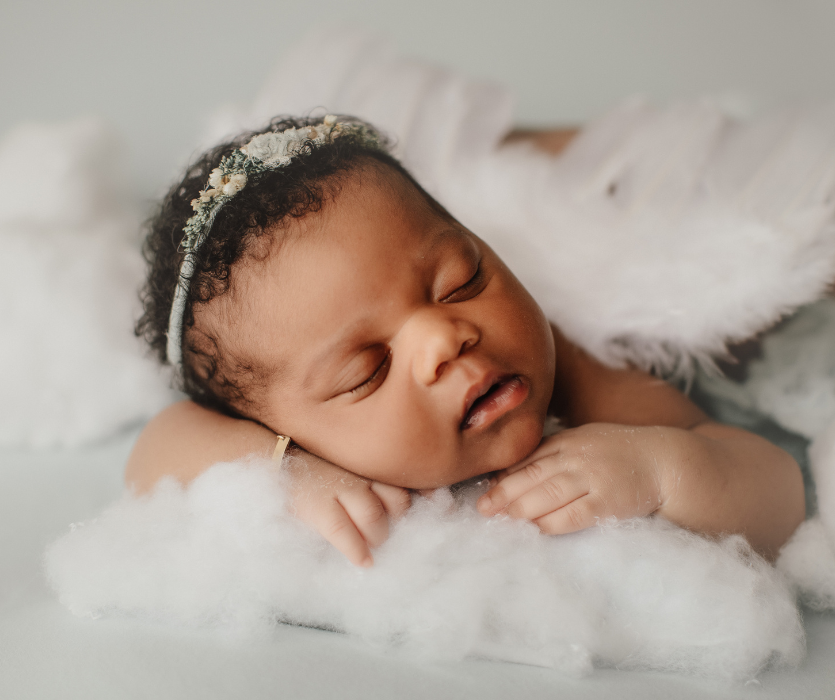 August baby sleeping on clouds