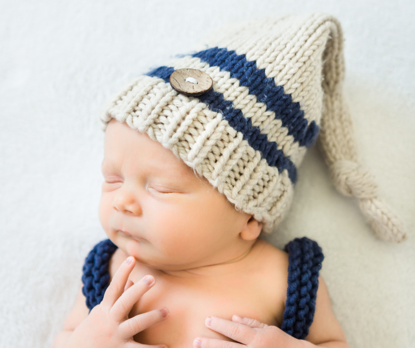 newborn baby with knitted hat for september