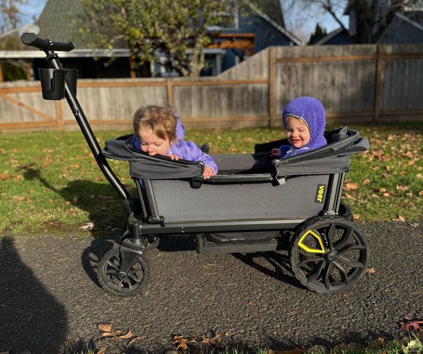 twin girls sitting in the Veer Cruiser wagon