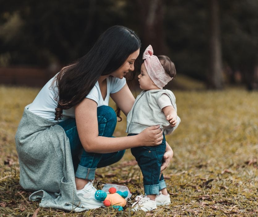 child with nanny outside