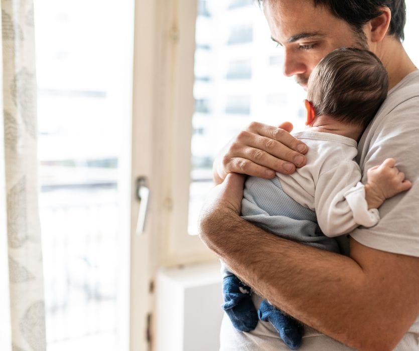 dad with postpartum depression holding baby