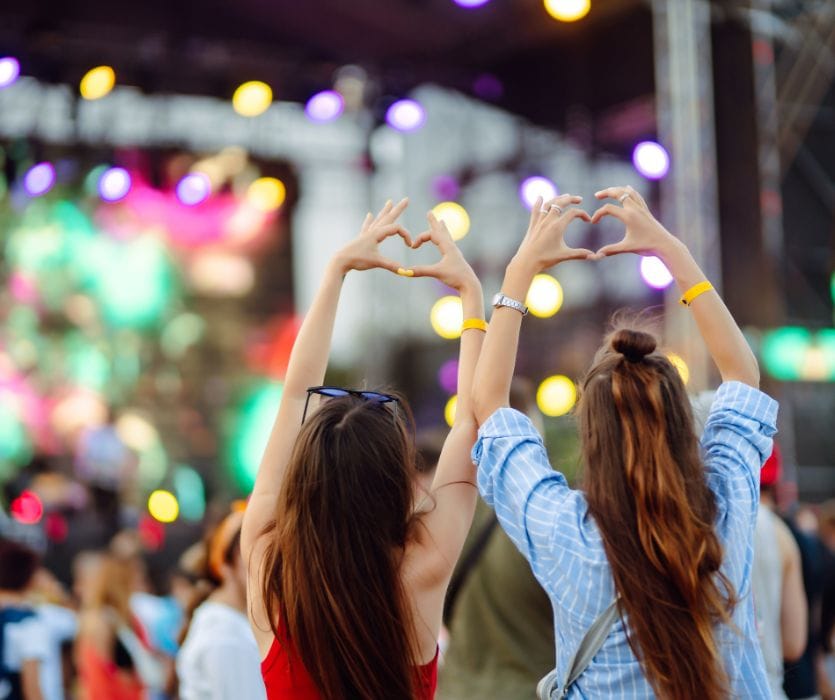 pregnant woman with her friend at a music concert