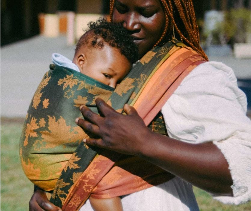 mother carrying her child in a woven wrap