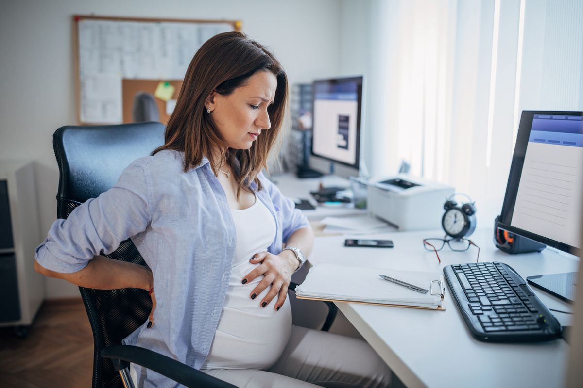 pregnant woman worried that her headache might be a dangerous pregnancy symptoms