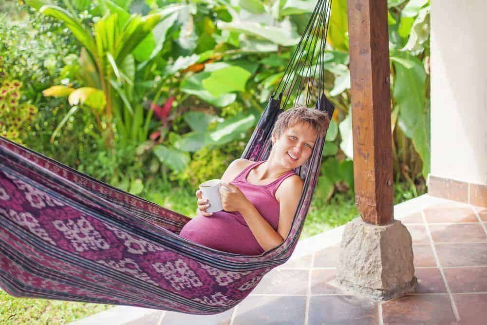 pregnant woman in a hammock on vacation in a tropical destination that has zika virus