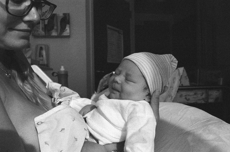 mom holding newborn baby in the hospital