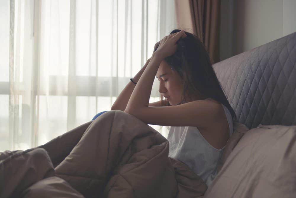 Pregnant woman in bed coping with prenatal depression