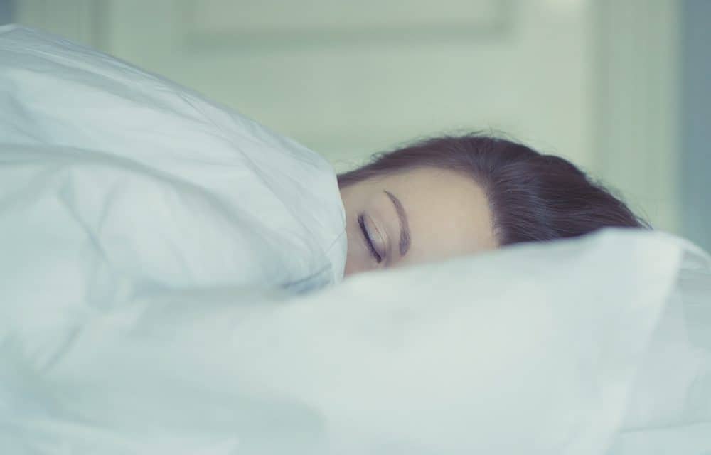 Woman sleeping in bed - sex life after baby