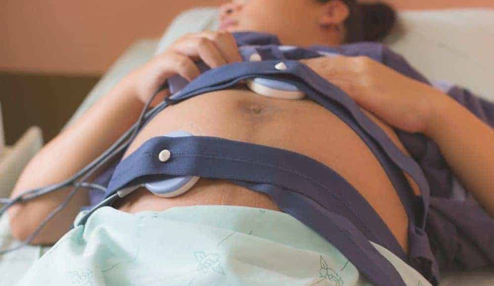 woman hooked up to medical equipment during a complicated pregnancy
