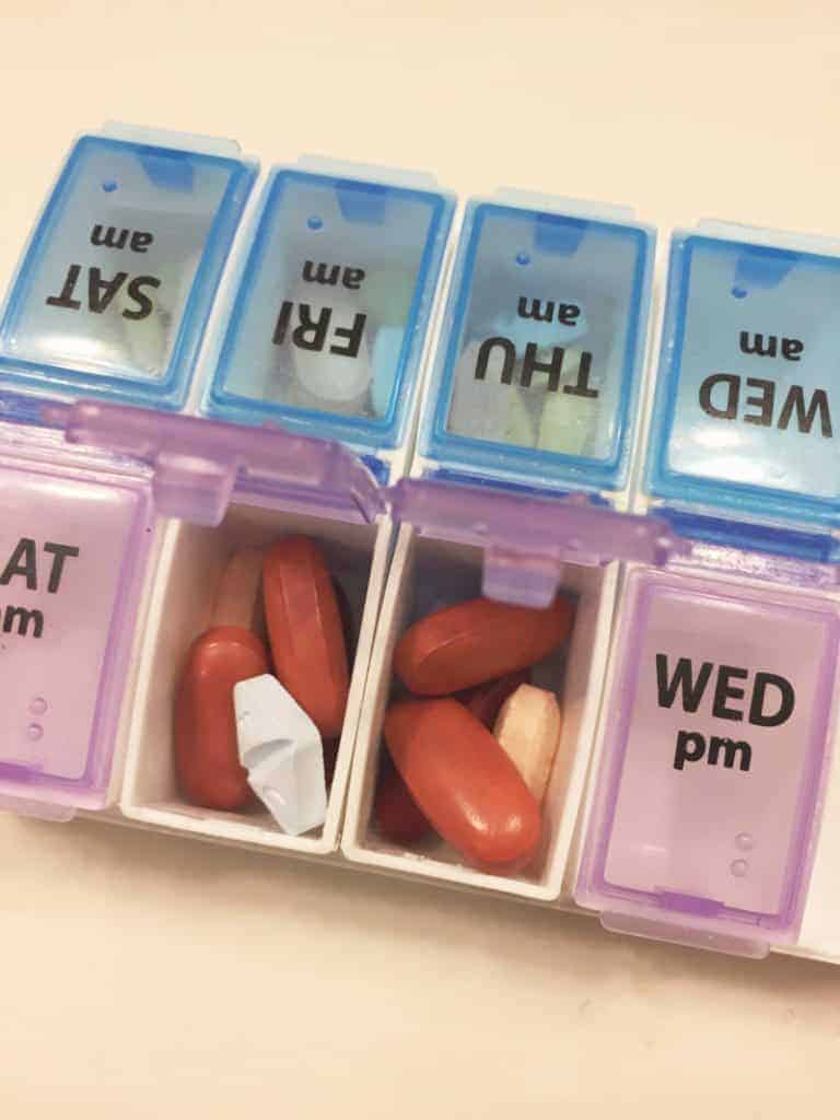 Medication Use in Pregnancy - pill boxes filled with medication