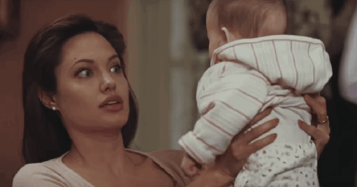 woman holding a baby unsure of whether she is ready to have kids