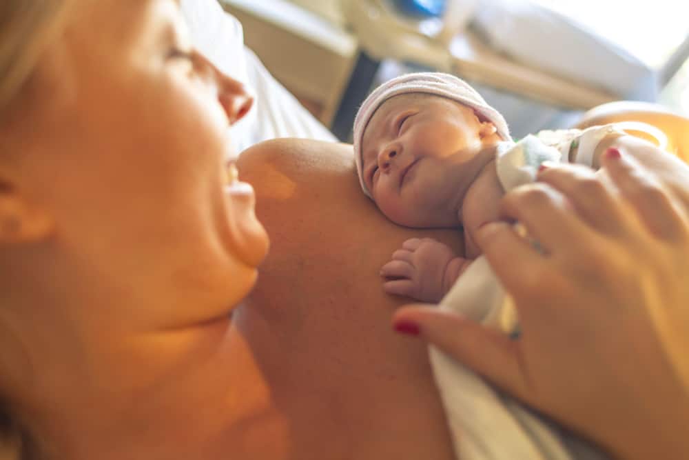Mom holding newborn after an unplanned pregnancy