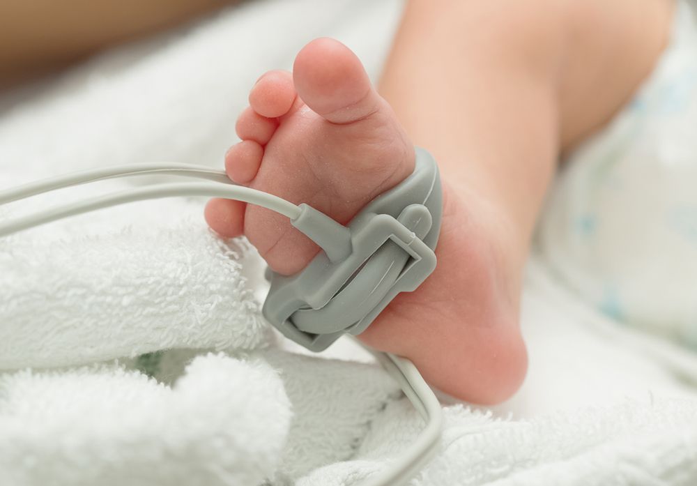baby Pulse oximeter sensor on a baby foot screening for a Congenital Heart Defect