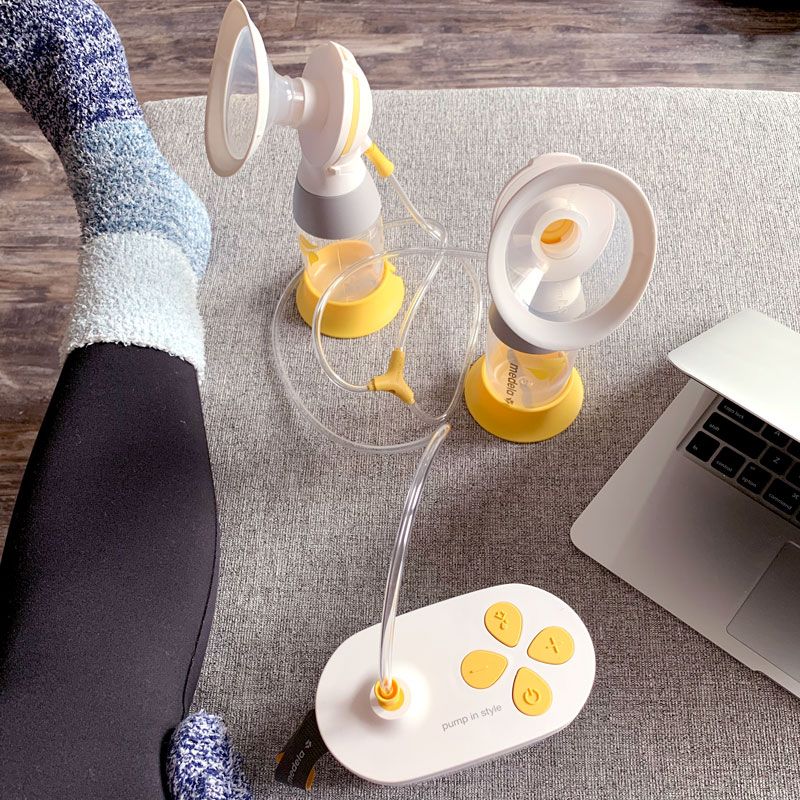 close up of woman's leg and Medela pump n style after picking a breast pump